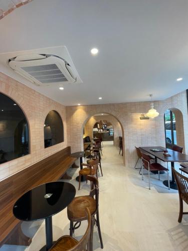 a restaurant with tables and chairs in a room at The Quarter Ploenchit by UHG in Bangkok