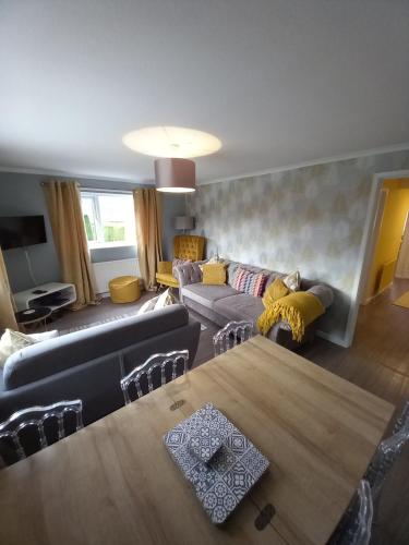 a living room with a couch and a table at Moore Apartment in Bourton on the Water