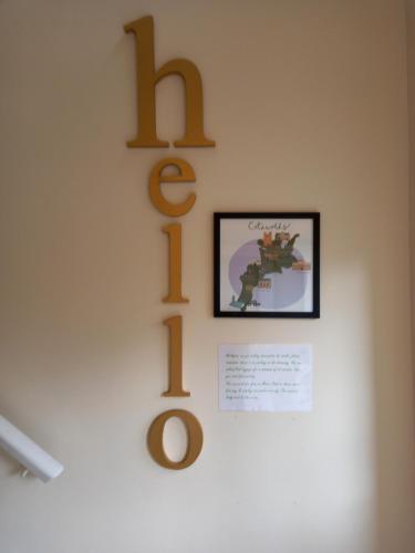 a sign on a wall with the word hug at Moore Apartment in Bourton on the Water