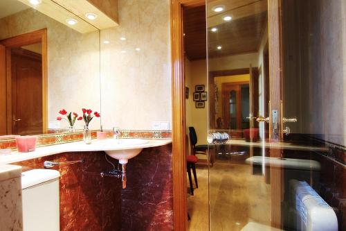 a bathroom with two sinks and a large mirror at Sea view, Wonderful pool, Nature, Peaceful & AC in Sant Cebrià de Vallalta