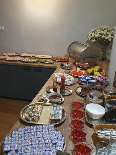 a table with many plates of food on it at Hotel Zieliniec in Poznań