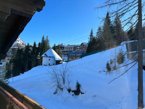 a snow covered hill with a small house on it at Haus Alpina in Sonnenalpe Nassfeld