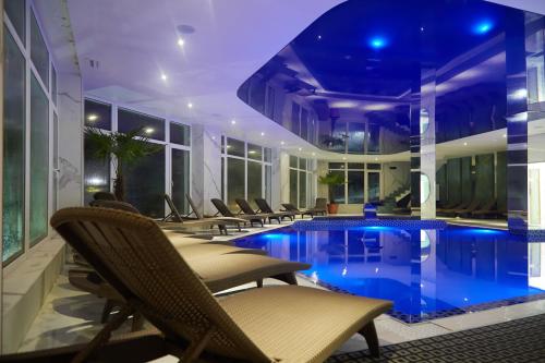 a hotel with a swimming pool in a building at SPA Resort HeRICH in Bukovel