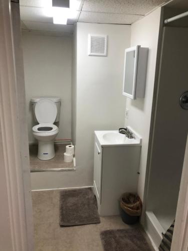 a small bathroom with a toilet and a sink at Art Gallery Hostel in Whitefield