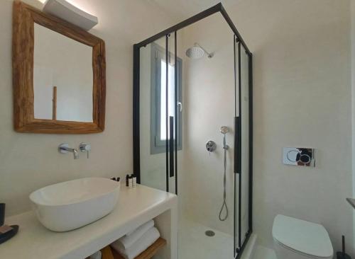 a bathroom with a sink and a shower at The Nine Graces - Kastraki Villas with Private Swimming Pool in Kastraki Naxou