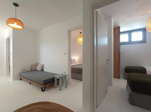 a living room with a bed and a room with a bedroom at The Nine Graces - Kastraki Villas with Private Swimming Pool in Kastraki Naxou