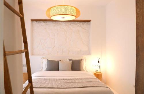 a bedroom with a bed with a large window at The Nine Graces - Kastraki Villas with Private Swimming Pool in Kastraki Naxou