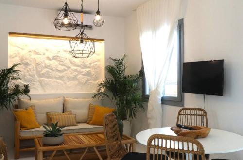 a living room with a couch and a table at The Nine Graces - Kastraki Villas with Private Swimming Pool in Kastraki Naxou