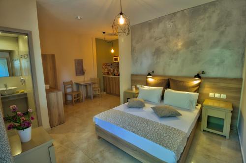 a bedroom with a bed and a bathroom at Two Brothers Studios & Apts in Kalamaki