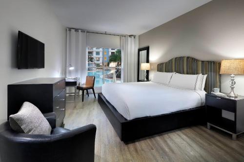 a bedroom with a bed and a desk and a chair at Meliá Orlando Celebration in Orlando
