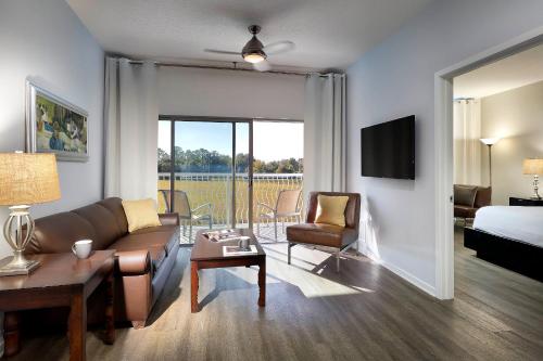 a living room with a couch and a bed at Meliá Orlando Celebration in Orlando