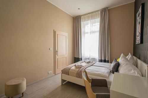 a hotel room with a bed and a window at Ruterra Apartment Charles Bridge in Prague
