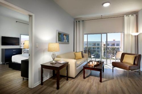 a living room with a couch and a bed at Meliá Orlando Celebration in Orlando