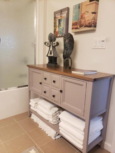 a dresser in a bathroom with a pile of towels at Penthouse Dreams in Irvine