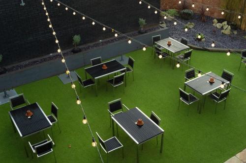 an overhead view of a patio with tables and chairs at Village Hotel Bracknell in Bracknell