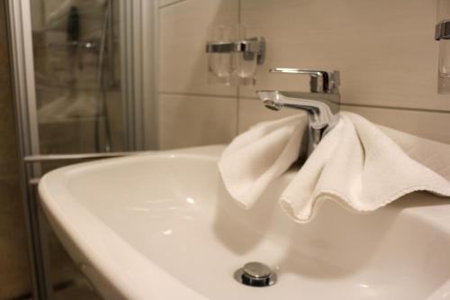 a bathroom sink with a towel hanging from a faucet at Haus Alpina in Sonnenalpe Nassfeld