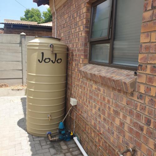 aige tank sitting on the side of a brick building at Lloyds - 3 in Ermelo