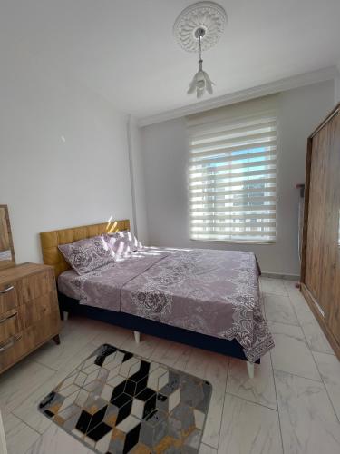 a bedroom with a bed and a window at BELKA GOLF RESİDENCE Poolside apt1 Belek in Belek