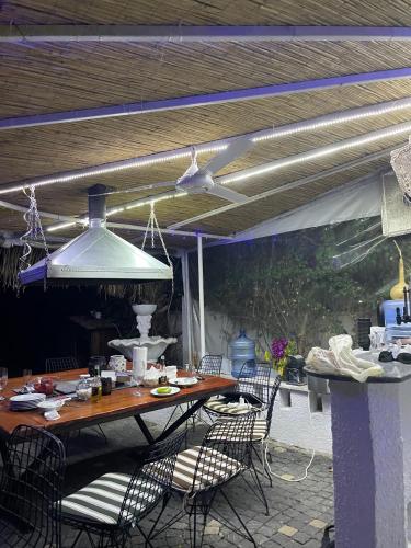 a table and chairs on a patio with a ceiling at BELKA GOLF RESİDENCE Poolside apt1 Belek in Belek