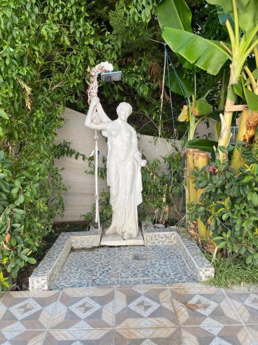 a statue of a woman holding a light at BELKA GOLF RESİDENCE Poolside apt1 Belek in Belek