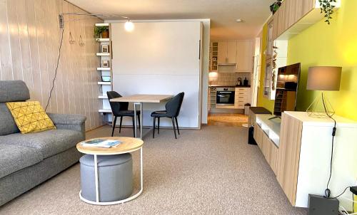 a small living room with a couch and a table at Ferienwohnung Kirchbichl am Schliersee mit Terrasse in Schliersee