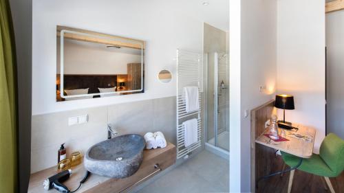 a bathroom with a sink and a mirror at Schnitzers Dahoam - Hundefreundlich in Bad Wiessee