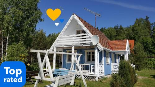 a tiny house with a heart balloon in the sky at Błękitny Domek - Tleń - Bory Tucholskie in Tleń