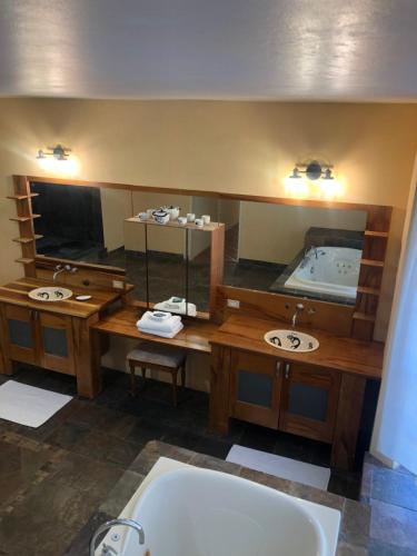 a bathroom with two sinks and a bath tub at Pura Vida Jamaica in Falmouth