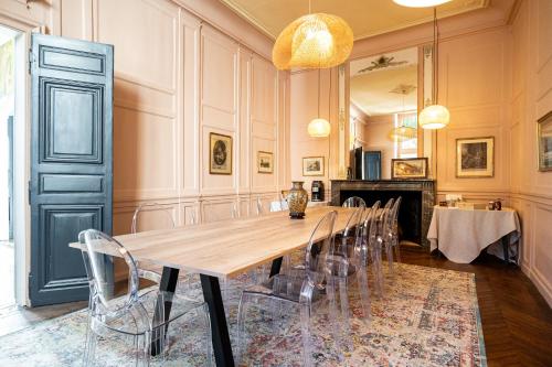 a large dining room with a long table and chairs at Le Henri IV in Le Mans