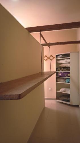 a walk in closet with a wooden shelf at Abrolhos Dive Inn in Caravellas