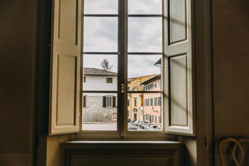 an open window with a view of a city at Palazzo Feroci - Residenza d'epoca in Pisa