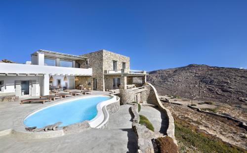 a villa with a swimming pool and a house at Villa Serenity in Mikonos