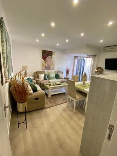 a living room with a couch and a table at Monte Gordo apartment in Monte Gordo