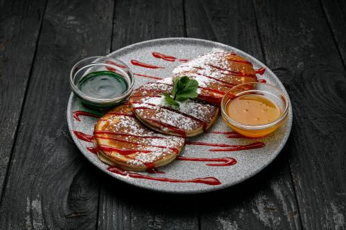 a plate of food on a wooden table at Campus Community A-Rooms in Kyiv