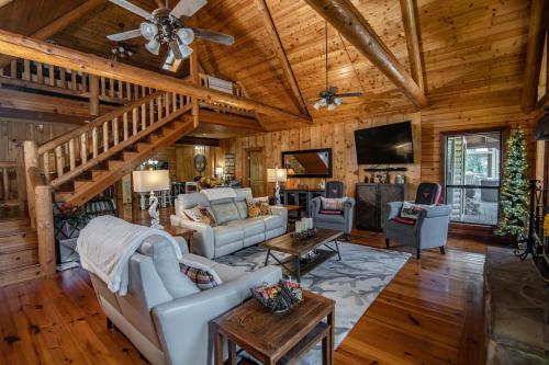 a living room filled with furniture and a wooden ceiling at River Wellness Lodge in Kingston