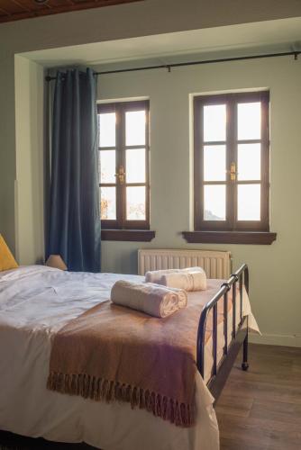 a bedroom with a bed with two towels on it at Charis Guesthouse in Makrinítsa