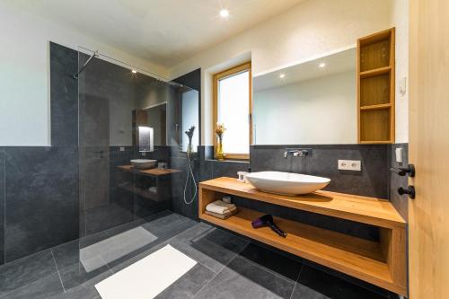 ein Bad mit einem Waschbecken und einer Dusche in der Unterkunft Ratscheinerhof App Gipfelglück in Latzfons