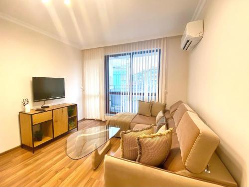 a living room with a couch and a television at Etica Apartments in Plovdiv