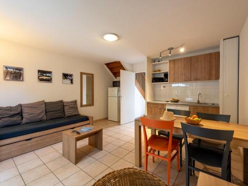 a living room and kitchen with a couch and a table at Holiday Home Cottage Confort 4 Pers- by Interhome in Saumur