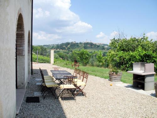 a table and chairs sitting on a gravel patio at Villa Le Fonti di Santa Lucia by Interhome in Poderi Foci