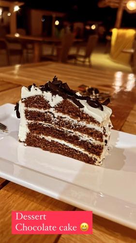 a piece of chocolate cake sitting on a plate at Paje Blu Boutique Hotel in Paje