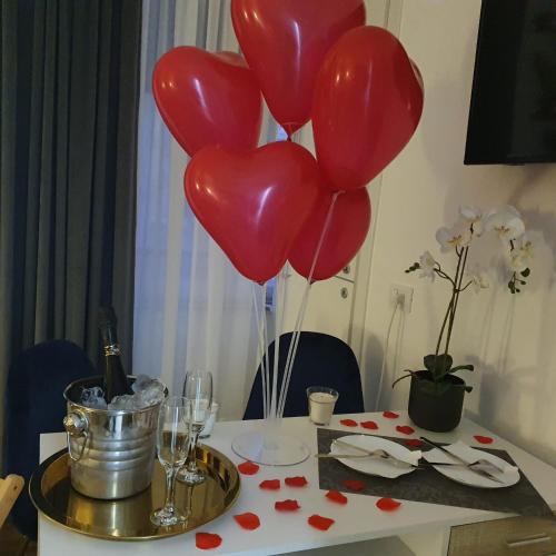 a bunch of red balloons on a table with hearts at Le Sciantose Relais in Naples