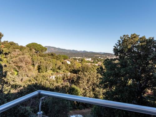 - un balcon avec vue sur une maison arborée dans l'établissement Holiday Home Villa Boccajo by Interhome, à Porto-Vecchio