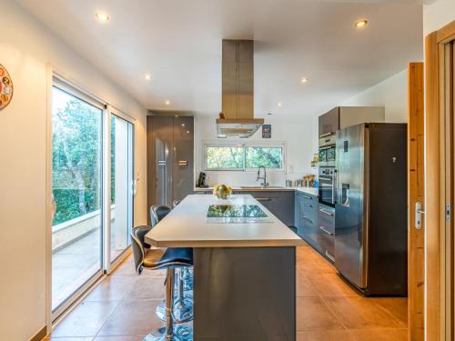 a kitchen with a stainless steel refrigerator and a counter at Holiday Home Villa Boccajo by Interhome in Porto-Vecchio
