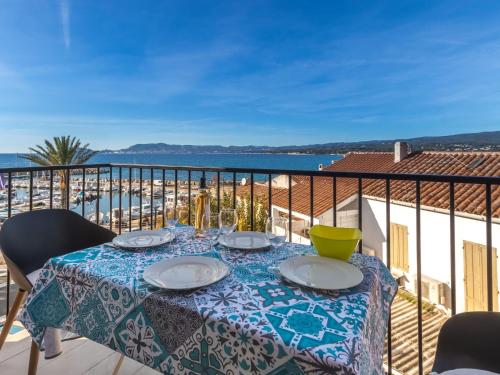 a table on a balcony with a view of the ocean at Holiday Home La Corniche by Interhome in La Madrague