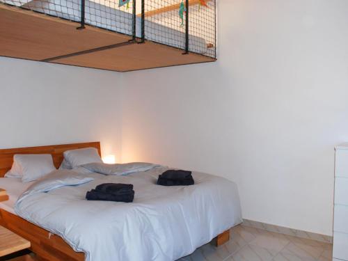 a bedroom with a bed with two bags on it at Apartment Casa Cavriana by Interhome in Magadino