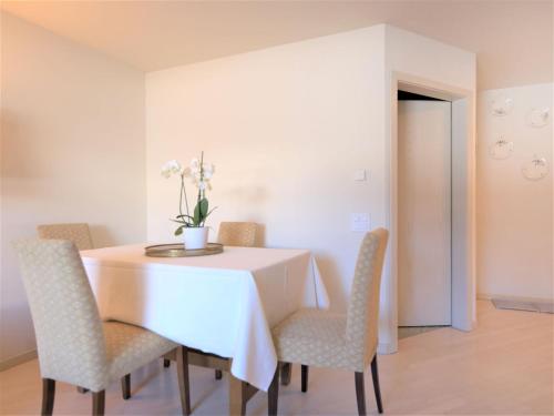 a dining room with a table and chairs at Apartment Chesa Sur Ova 22 by Interhome in St. Moritz