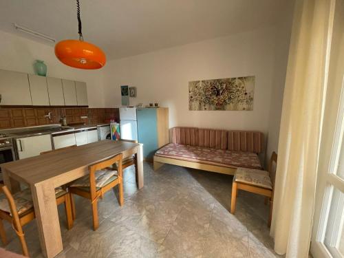 a kitchen with a table and a couch in a room at casa comoda a due passi dal mare in Il Monte