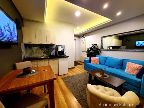 a living room with a blue couch and a table at Katanera 2 in Kraljevo