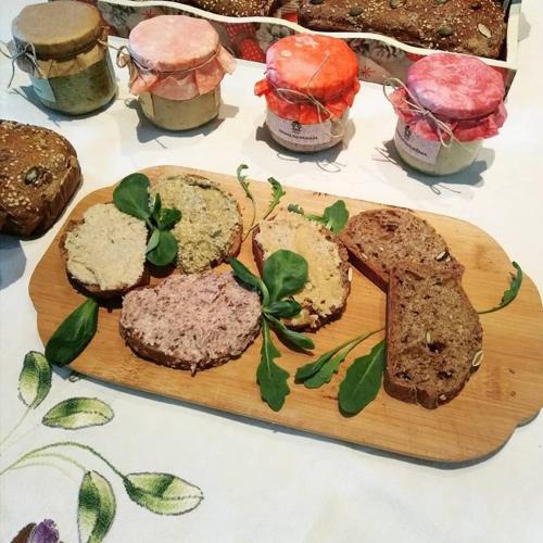 a cutting board with different types of bread on a table at Podrum Miljević in Ledinci